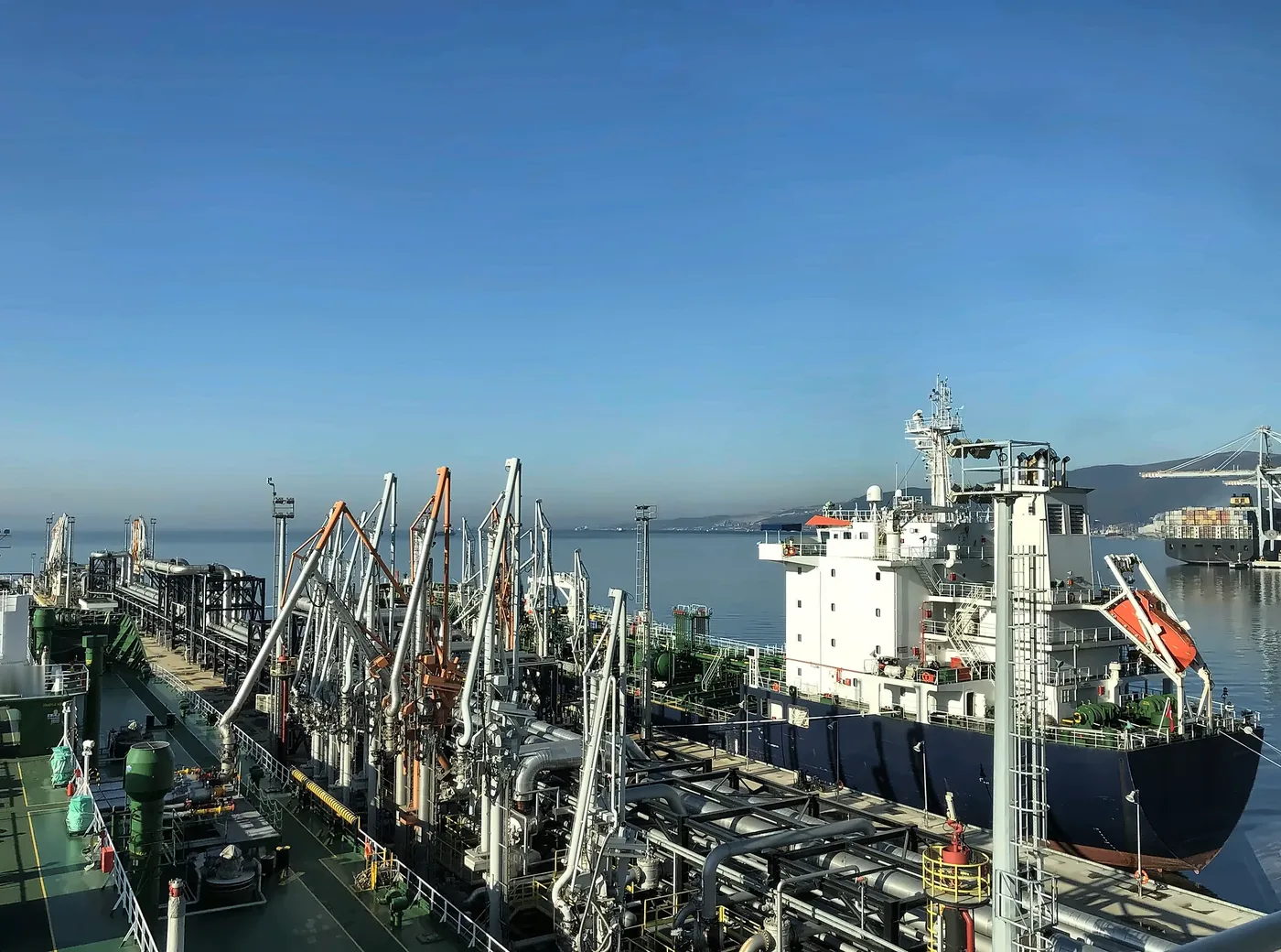 Loading arms on a tanker jetty, with a tanker alongside
